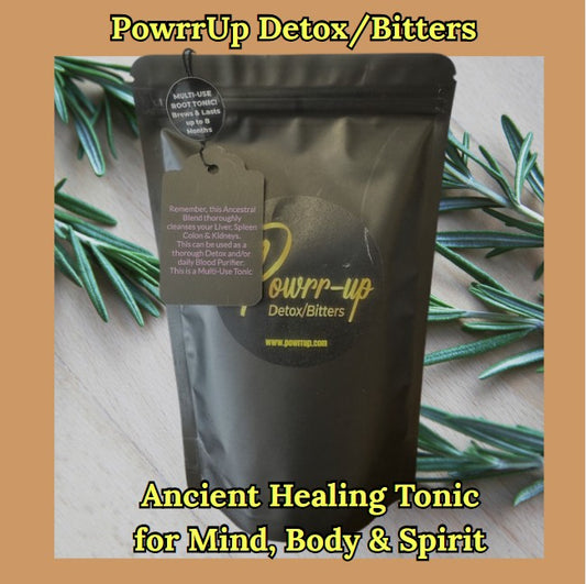 "PowrrUp Detox/Bitters black pouch with gold logo, labeled as a Multi-Use Root Tonic. The package highlights its use as an Ancient Healing Tonic for Mind, Body & Spirit. Surrounded by sprigs of rosemary on a wooden surface."